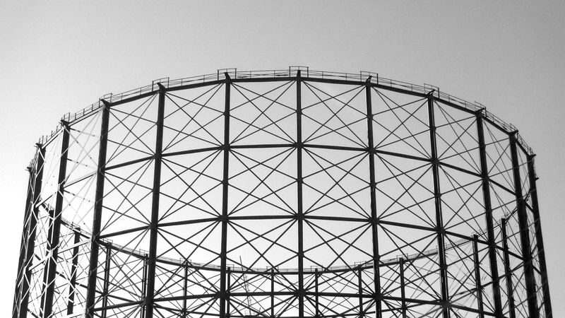 A black and white photo of one of those gas tower things