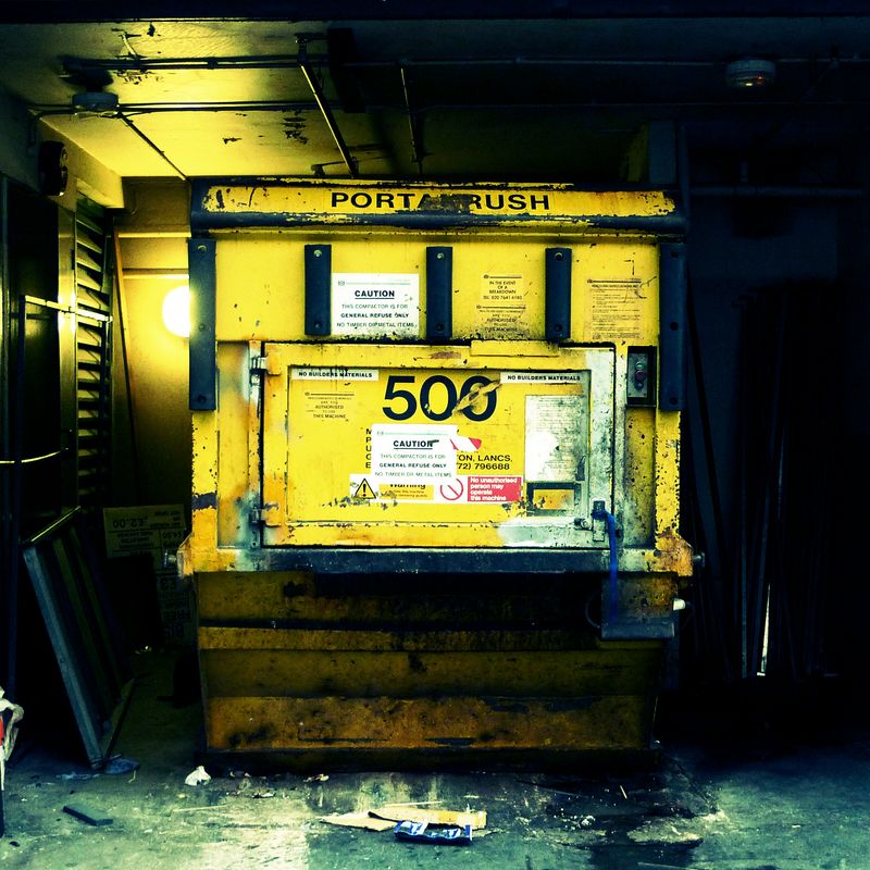 A photo of a skip in London. It says PORTACRUSH on it