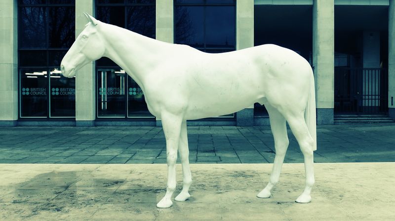 A photo of a statue of a white horse outside the British Council